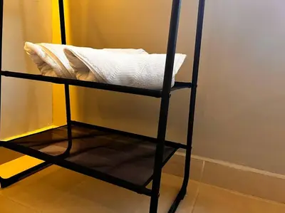 a black chair with a white pillow on it at POBLADO PARK LUXURY APARTMENT's in Medellín