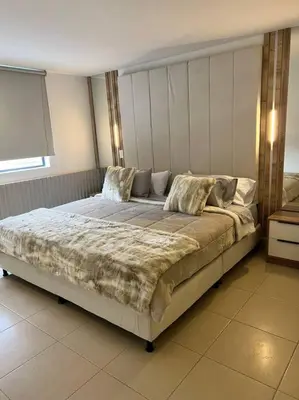 a bedroom with a large bed in a room at POBLADO PARK LUXURY APARTMENT's in Medellín