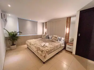 a bedroom with a large bed in a room at POBLADO PARK LUXURY APARTMENT's in Medellín
