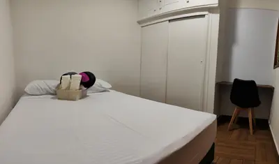 a white bed with a basket on top of it at Casa primer piso Laureles, Estadio, UPB, la 70 in Medellín