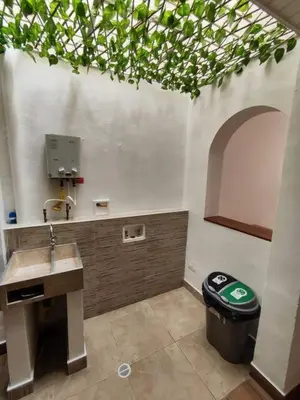 a bathroom with a sink and a trash can at Casa primer piso Laureles, Estadio, UPB, la 70 in Medellín