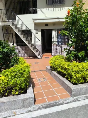 a brick walkway in front of a building with stairs at Casa primer piso Laureles, Estadio, UPB, la 70 in Medellín