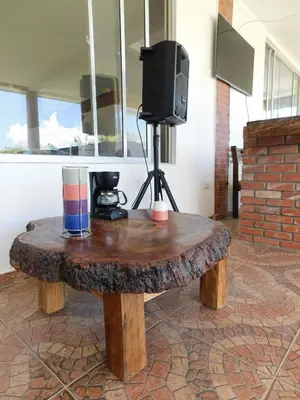 a wooden coffee table with a tv on top of it at Hostal Santa Teresita in La Merced