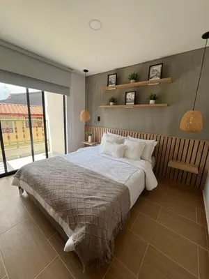 a bedroom with a large bed and a large window at Casa Berlín, Lake Access in Guatapé