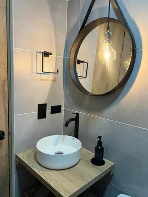 a bathroom with a white sink and a mirror at Casa Berlín, Lake Access in Guatapé
