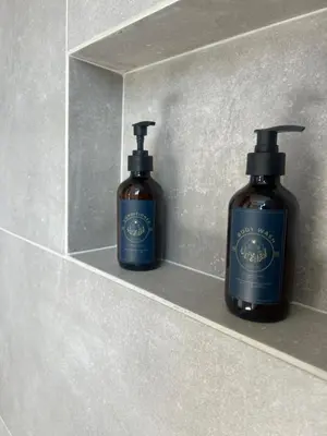 two bottles of soap sitting on a shelf at Casa Berlín, Lake Access in Guatapé
