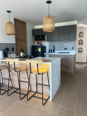 a kitchen with a kitchen island with stools at Casa Berlín, Lake Access in Guatapé