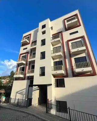 a tall white building with balconies on it at Casa Berlín, Lake Access in Guatapé