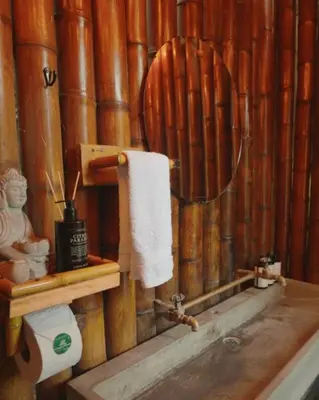 a wooden bathroom with a toilet and a towel at ATTRAVERSIAMO BAMBOO HOUSE in Manizales