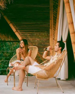 a group of people sitting in chairs drinking wine at ATTRAVERSIAMO BAMBOO HOUSE in Manizales