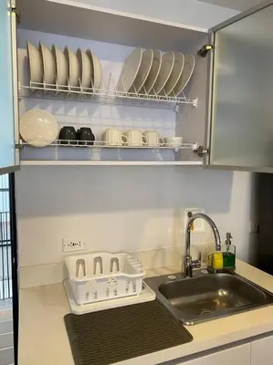a kitchen counter with a sink and plates and dishes at Apartamento Lauret 2 en Laureles in Medellín