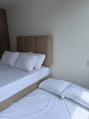 a bed with two pillows in a room at Apartamento Lauret 2 en Laureles in Medellín