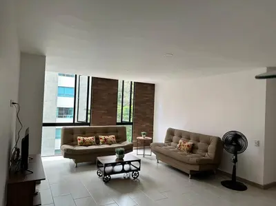 a living room with two couches and a table at Apartamento Lauret 2 en Laureles in Medellín