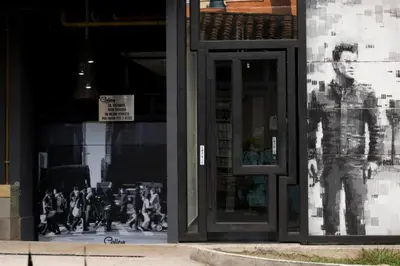 a store front with a picture of a man on the window at Hotel Medellin Arte in Medellín