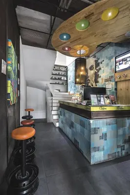 a restaurant with a bar with a counter and a stool at Hotel Medellin Arte in Medellín