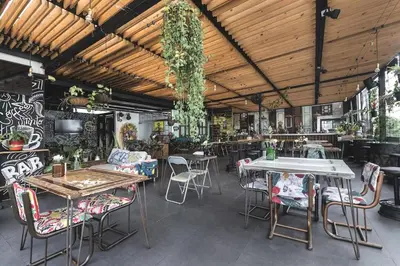 a restaurant with tables and chairs in a room at Hotel Medellin Arte in Medellín
