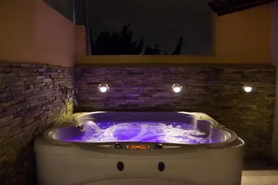 a bath tub with purple lighting in a room at Apartamento Lleras AC Hot Tub in Medellín