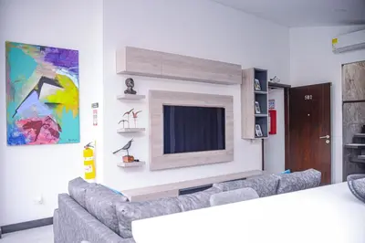 a living room with a couch and a tv at Apartamento Lleras AC Hot Tub in Medellín