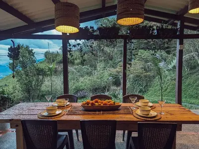 a wooden table with a bowl of fruit on it at Casa Nutabe - Casa de Campo en Girardota cerca a Medellín in Girardota