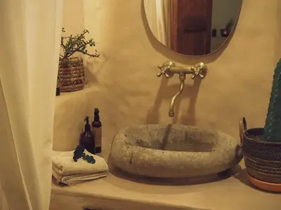 a bathroom with a stone sink and a mirror at Casa Nutabe - Casa de Campo en Girardota cerca a Medellín in Girardota