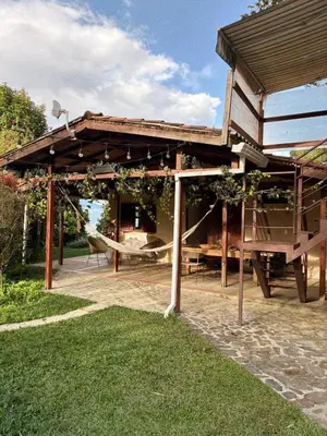 a wooden pavilion with a hammock in a yard at Casa Nutabe - Casa de Campo en Girardota cerca a Medellín in Girardota