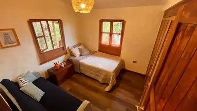 a bedroom with a bed and a couch in it at Casa Nutabe - Casa de Campo en Girardota cerca a Medellín in Girardota