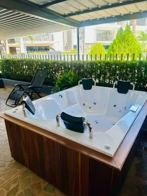 a bath tub with two faucets on top of it at Apartasol Santa Fe de Antioquia in Santa Fe de Antioquia