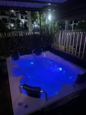a blue hot tub in a backyard at night at Apartasol Santa Fe de Antioquia in Santa Fe de Antioquia