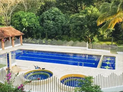 a swimming pool with a white fence around it at Villa Luz in San Jerónimo