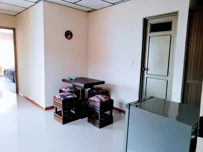 a room with a table and stools in it at Apartaestudio central con balcón y wifi en Riosucio in Ruiosucio