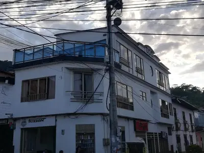 a white building with a balcony on top of it at Apartaestudio central con balcón y wifi en Riosucio in Ruiosucio