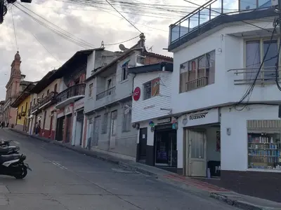 a street with buildings and a motorcycle parked on the street at Apartaestudio central con balcón y wifi en Riosucio in Ruiosucio