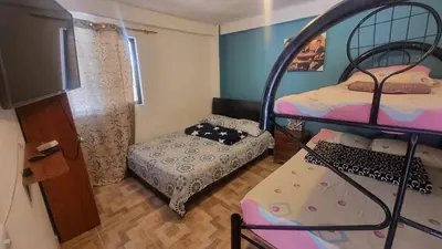 a bedroom with two bunk beds and a small bed at Cabaña vacacinal in Cocorná