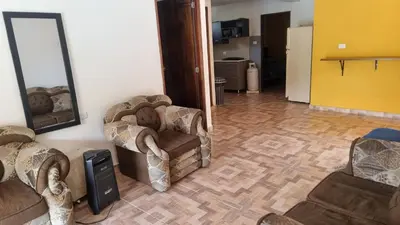 a living room with two chairs and a mirror at Cabaña vacacinal in Cocorná