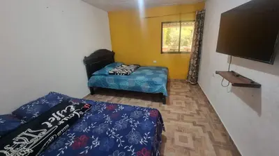 a room with a bed and a flat screen tv at Cabaña vacacinal in Cocorná