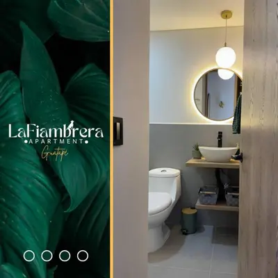 a bathroom with a white toilet and a mirror at Nuevo apto con acceso al embalse en Guatapé in Guatapé