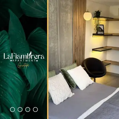 a bedroom with a bed with two pillows and a chair at Nuevo apto con acceso al embalse en Guatapé in Guatapé