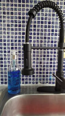 a bottle of soap sitting next to a sink at Casa en Laureles Ideal para Familias in Medellín