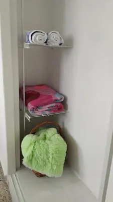a towel rack with a green heart shaped pillow in a room at Casa en Laureles Ideal para Familias in Medellín
