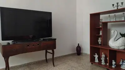 a flat screen tv sitting on a wooden stand in a room at Casa en Laureles Ideal para Familias in Medellín