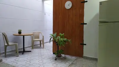 a room with a table and a clock on the wall at Casa en Laureles Ideal para Familias in Medellín