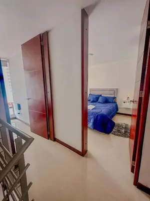 a bedroom with a bed and a sliding glass door at Apartamento Duplex en ubicacion privilegiada in Manizales