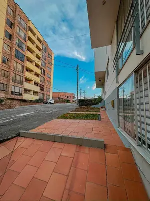 an empty sidewalk next to a street with buildings at Apartamento Duplex en ubicacion privilegiada in Manizales