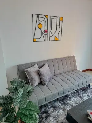 a couch in a living room with a painting on the wall at Apartamento Duplex en ubicacion privilegiada in Manizales