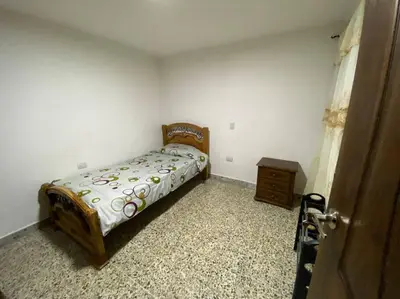 a bedroom with a bed and a dresser in it at Acogedora casa en Bello Antioquia in Bello