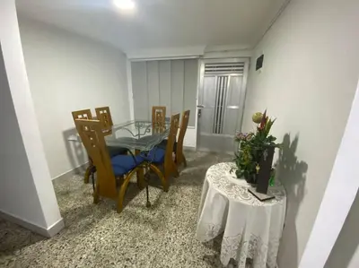 a dining room with a glass table and chairs at Acogedora casa en Bello Antioquia in Bello