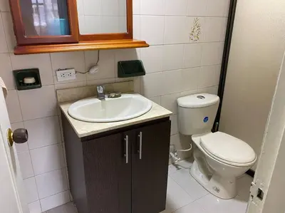 a small bathroom with a toilet and a sink at Acogedora casa en Bello Antioquia in Bello