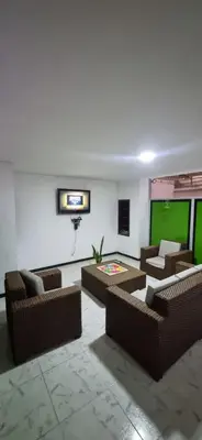 a living room with couches and a green screen at Casa grande en el centro de la cuidad in Medellín
