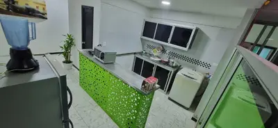 a kitchen with a stove and a green counter top at Casa grande en el centro de la cuidad in Medellín