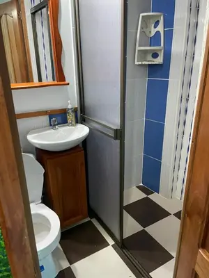 a small bathroom with a toilet and a sink at Habitación La Amelia in Jericó